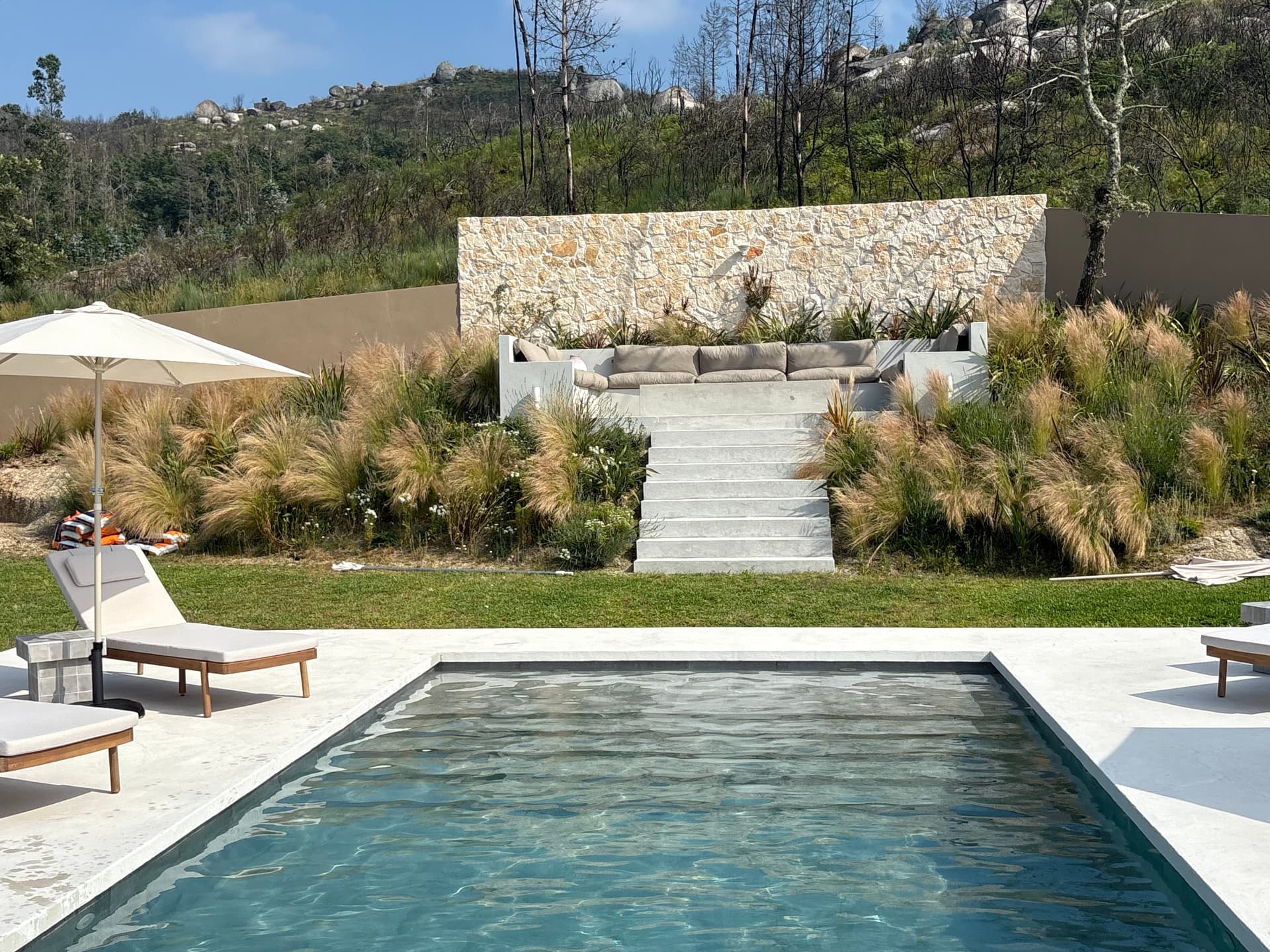 Pool terrace with stone steps up to the lounge area